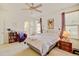 Serene bedroom with a ceiling fan, a window, and a reading nook with carpet flooring at 4312 Windmill Dr, Brighton, CO 80601