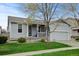 Charming single-story home with a well-manicured lawn, covered porch, and attached two-car garage at 4312 Windmill Dr, Brighton, CO 80601