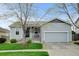 Charming single-story home with a well-manicured lawn, covered porch, and attached two-car garage at 4312 Windmill Dr, Brighton, CO 80601