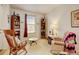 Cozy living room with carpet, featuring bookcases filled with books and comfortable seating at 4312 Windmill Dr, Brighton, CO 80601