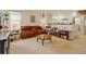 Spacious living room with comfortable leather seating, neutral carpet, and bright natural light at 4312 Windmill Dr, Brighton, CO 80601