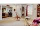 Inviting living room with neutral carpet, a rocking chair, and plenty of natural light from the window at 4312 Windmill Dr, Brighton, CO 80601