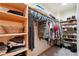 Walk-in closet features built-in wooden shelving for clothes, shoes, and other accessories at 1025 Birch Ave, Fort Lupton, CO 80621