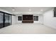 Open basement featuring a sleek entertainment center and stylish sliding barn door at 3112 Braun Ct, Golden, CO 80401