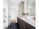Modern bathroom featuring black marble floors, stylish vanity with gold fixtures, and ample storage space at 3112 Braun Ct, Golden, CO 80401