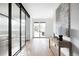 A hallway features a glass divider, hardwood floors, and a sliding glass door to the backyard at 3112 Braun Ct, Golden, CO 80401