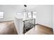 Upstairs landing features hardwood floors, modern lighting, and natural light from windows at 3112 Braun Ct, Golden, CO 80401