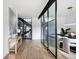 An open hallway features hardwood floors, a glass divider and staircase leading to a second level at 3112 Braun Ct, Golden, CO 80401