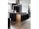 Modern kitchen island with bar seating and sleek stainless steel hood at 3112 Braun Ct, Golden, CO 80401