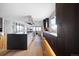 A modern kitchen with stainless steel appliances and dark wood cabinets boasts an open floorplan and hardwood floors at 3112 Braun Ct, Golden, CO 80401