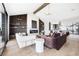 Open living room with fireplace, plush seating, and seamless flow to kitchen at 3112 Braun Ct, Golden, CO 80401