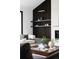 Living room with modern accents, wood slat wall feature, and stylish shelves at 3112 Braun Ct, Golden, CO 80401