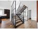 Modern staircase with hardwood steps and a glass enclosure, open to a living space with dark cabinets at 3112 Braun Ct, Golden, CO 80401