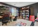Bedroom features large black bookcase filled with anime and mangas and a dedicated gaming setup at 23376 E 5Th Pl # 201, Aurora, CO 80018