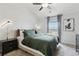Bright bedroom featuring a large bed with green linens, minimalist decor, and natural light at 23376 E 5Th Pl # 201, Aurora, CO 80018