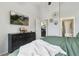 Bedroom featuring a TV, dresser, and open access to the laundry and bathroom at 23376 E 5Th Pl # 201, Aurora, CO 80018