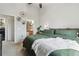 Bright bedroom features a ceiling fan, minimalist decor, and ensuite bathroom access at 23376 E 5Th Pl # 201, Aurora, CO 80018