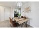 Cozy dining area with wooden table, four chairs, unique light fixture, and direct access to the laundry room at 23376 E 5Th Pl # 201, Aurora, CO 80018