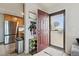 Entryway showcasing tiled floors, and an open floor plan with a view of the stainless steel refrigerator in the adjacent kitchen at 23376 E 5Th Pl # 201, Aurora, CO 80018