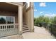 The exterior of the home features private balcony space, wooden stairs, and a walkway with views of the surrounding landscape at 23376 E 5Th Pl # 201, Aurora, CO 80018