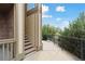 A walkway with iron railing leads to this homes private balcony and staircase with a view of the surrounding landscape at 23376 E 5Th Pl # 201, Aurora, CO 80018