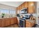 Updated kitchen featuring granite countertops, stainless appliances, wooden cabinets and luxury vinyl plank flooring at 23376 E 5Th Pl # 201, Aurora, CO 80018