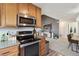 A kitchen with stainless steel appliances that transitions into the open-concept living and dining areas, perfect for entertaining at 23376 E 5Th Pl # 201, Aurora, CO 80018