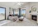 Bright living room with vaulted ceiling, fireplace, plush carpet, and sliding door access to private balcony at 23376 E 5Th Pl # 201, Aurora, CO 80018