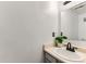 Bathroom with beige vanity, bronze faucet and a green leafy plant at 12556 Elm St, Thornton, CO 80241