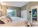 Cozy bedroom with large window, closet and view of a neighboring home at 12556 Elm St, Thornton, CO 80241