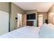 Bright bedroom showcasing an ensuite bathroom, closet and TV at 12556 Elm St, Thornton, CO 80241