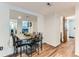 Cozy dining room featuring hardwood floors, a large mirror, and a view into the living room at 12556 Elm St, Thornton, CO 80241