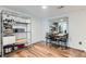 Open dining area featuring hardwood floors, adjacent storage and view of the kitchen at 12556 Elm St, Thornton, CO 80241