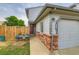 Inviting townhouse entrance featuring a red door, brick accents, and green lawn at 12556 Elm St, Thornton, CO 80241