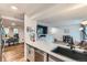 Open concept kitchen with quartz countertops, stainless steel dishwasher, and seamless flow to dining area at 12556 Elm St, Thornton, CO 80241