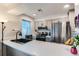 Modern kitchen featuring sleek gray cabinets, stainless steel appliances, and ample countertop space at 12556 Elm St, Thornton, CO 80241