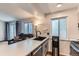 Open concept with modern kitchen featuring quartz countertops and updated appliances at 12556 Elm St, Thornton, CO 80241