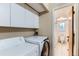 Convenient laundry area with modern washer and dryer, and bathroom access at 12556 Elm St, Thornton, CO 80241