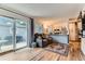 Bright living room with hardwood floors, sliding glass doors, and a view to the backyard at 12556 Elm St, Thornton, CO 80241