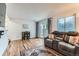 Comfortable living room with hardwood floors, large window, and view of the backyard at 12556 Elm St, Thornton, CO 80241
