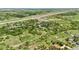 Aerial view showcasing the neighborhood homes surrounded by open grassland and a distant highway at 9053 Clydesdale Rd, Castle Rock, CO 80108