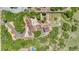 Aerial view of a home showcasing an expansive backyard with lush landscaping, a horse barn with solar panels, and ample acreage at 9053 Clydesdale Rd, Castle Rock, CO 80108