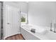 Relaxing bathtub with a view from the window and bright natural light at 9053 Clydesdale Rd, Castle Rock, CO 80108