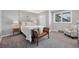 Cozy carpeted bedroom with a neutral color palette, a large window, and closet at 9053 Clydesdale Rd, Castle Rock, CO 80108