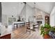 Open-concept dining room with vaulted ceilings, fireplace, and breakfast bar seating at 9053 Clydesdale Rd, Castle Rock, CO 80108