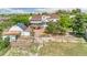 Aerial view of a stunning white home with a horse barn with solar, fenced pastures and lush greenery, set in a tranquil surrounding at 9053 Clydesdale Rd, Castle Rock, CO 80108