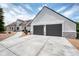 Front exterior highlighting the three-car garage and concrete driveway at 9053 Clydesdale Rd, Castle Rock, CO 80108