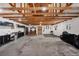 Spacious garage with ample storage space, work bench, and exposed ceiling beams at 9053 Clydesdale Rd, Castle Rock, CO 80108