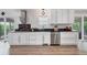 White kitchen cabinets, subway tile backsplash, and stainless steel appliances at 9053 Clydesdale Rd, Castle Rock, CO 80108
