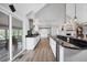Spacious, updated kitchen with breakfast bar, stainless hood, and adjoining sunroom at 9053 Clydesdale Rd, Castle Rock, CO 80108